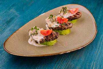veal on zucchini with mushroom sauce