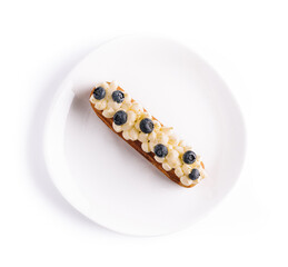 Eclair with vanilla cream and blueberries