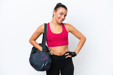 Young sport woman with sport bag isolated on white background posing with arms at hip and smiling