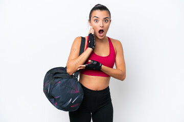 Young sport woman with sport bag isolated on white background surprised and shocked while looking...