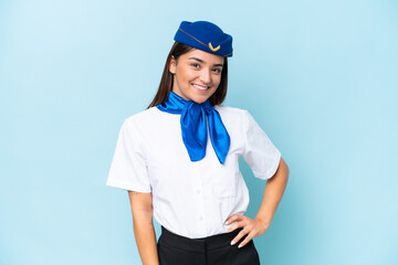 Airplane stewardess caucasian woman isolated on blue background laughing