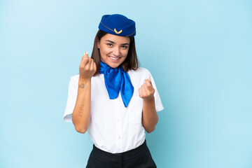 Airplane stewardess caucasian woman isolated on blue background making money gesture