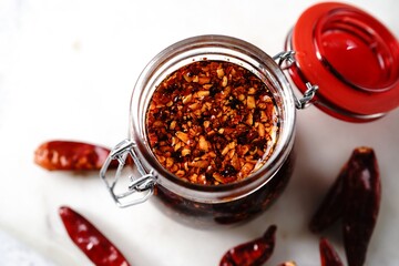 Homemade Asian chilli oil in a glass jar, selective focus