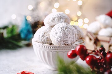 Fototapeta na wymiar Homemade Snowball or Mexican wedding cookies on holiday background, selective focus