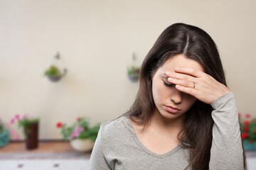 Sad or sick woman with headache, feeling stressed