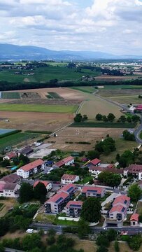Vertical video of Aerial shot of a village on a hill and the countryside around