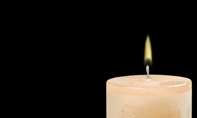Burning candle light on dark background
