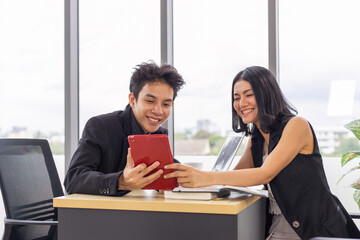 Businessman and businesswoman meeting and working together with tablet.