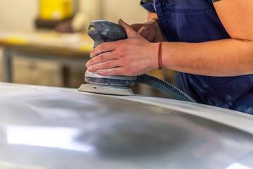 Bulgarian mechanic working in auto shop.