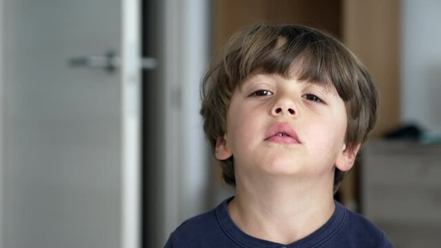 One fed up little boy. Portrait of a bored child feeling annoyed. Close up face of a kid feeling upset