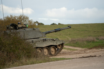 a British army FV4034 Challenger 2 ii main battle tank breaks cover on a military combat exercise,...