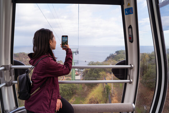 Woman taking picture in cable car