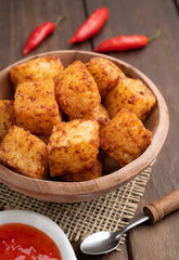 Tapioca dice, typical northeast brazilian food with chilli pepper syrup over wooden table