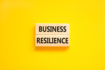 Business resilience symbol. Concept word Business resilience typed on wooden blocks. Beautiful yellow table yellow background. Business and business resilience concept. Copy space.