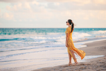 Young beautiful woman on the beach vacation enjoy the sunset