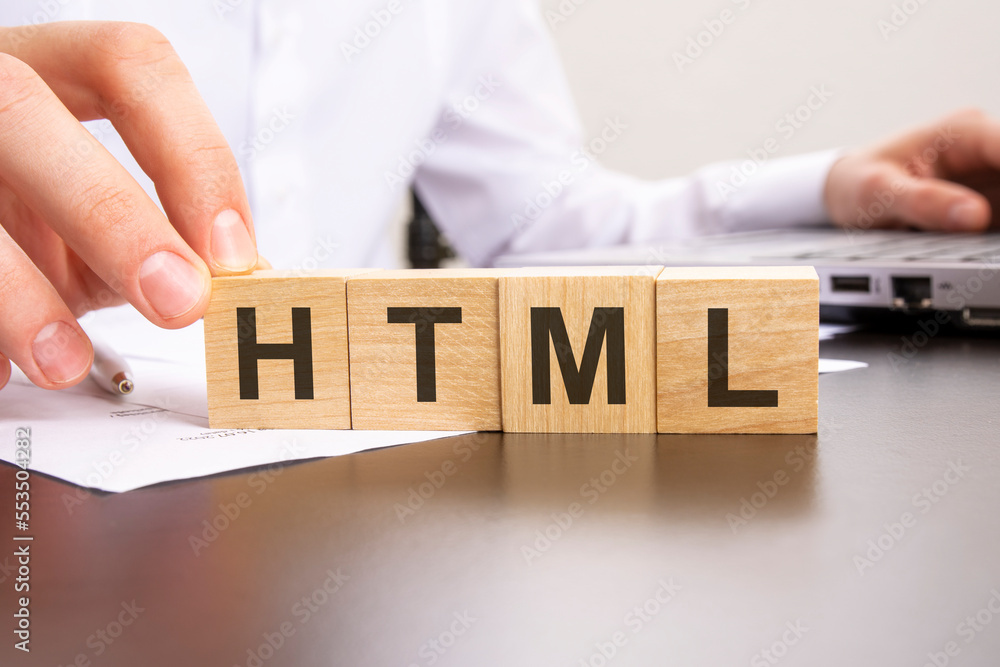 Poster man made word html with wood blocks on the background of the office table. selective focus. business