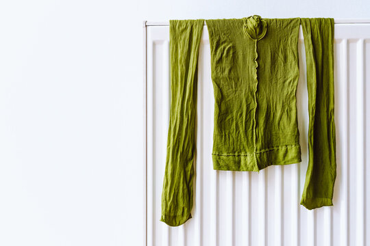 Green Nylon Tights Turned Inside Out Hang On Radiator To Dry