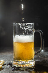 Light beer in a glass on a dark background