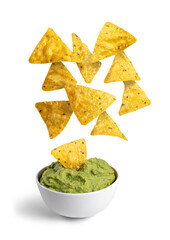 Nachos falling on a bowl with guacamole isolated on the white background
