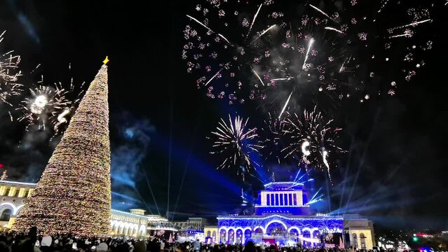 Amazing Night opening ceremony of Junior Eurovision 2022 on December 5, Beautiful color fireworks over Christmas tree, New year tree lighting ceremony 2023 concept. 4k footage