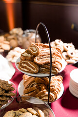 Sliced spiral cream filled pumpkin roll on tiered dessert plate