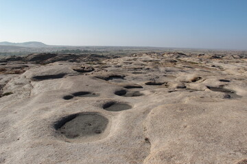 Flat volcanic plateau with small hills and pits in the Bektau-Ata tract, distant view of the valley to the horizon, panorama