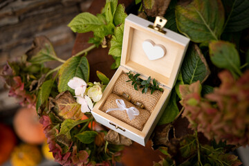 wedding rings in a box with flowers