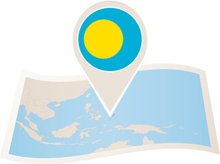 Folded paper map of Palau with flag pin of Palau.