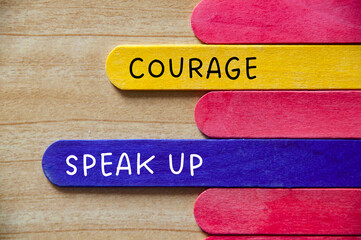 Courage and speak up text on wooden stick. Business culture value concept.