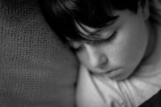 Close-up Of Boy With Bangs Asleep On The Armchair