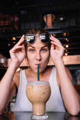 Woman drinking a iced coffee with a straw