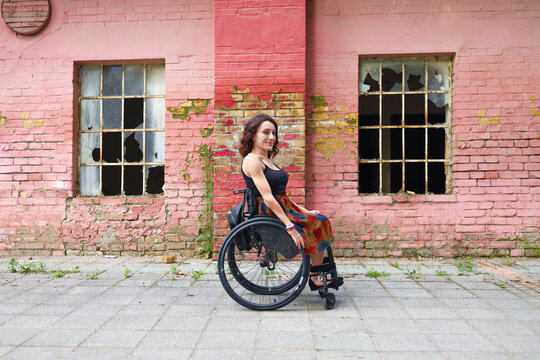 Young determined woman with paraplegia smiling.