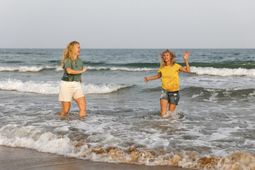 Girlfriends walk and have fun at the sea, family vacation at sea