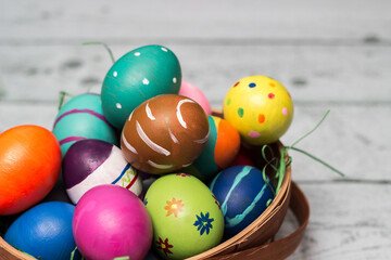 Basket with painted colorful easter eggs