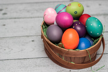 Basket with painted colorful easter eggs