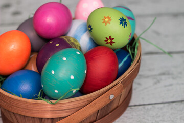 Basket with painted colorful easter eggs