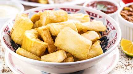 fried sweet cassava, served with vegetables and spices, typical Brazilian food, brazilian restaurant food