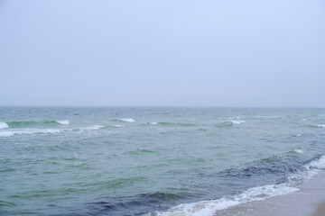 Fototapeta premium Undulating Baltic Sea in autumn foggy weather.