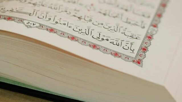 The Holy Quran Book, koran Chapter, flipping pages Close up Macro.