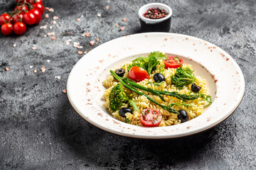 Greek Pasta Salad with tomato, avocado, black olives, red onions and cheese feta. Restaurant menu, dieting, cookbook recipe top view