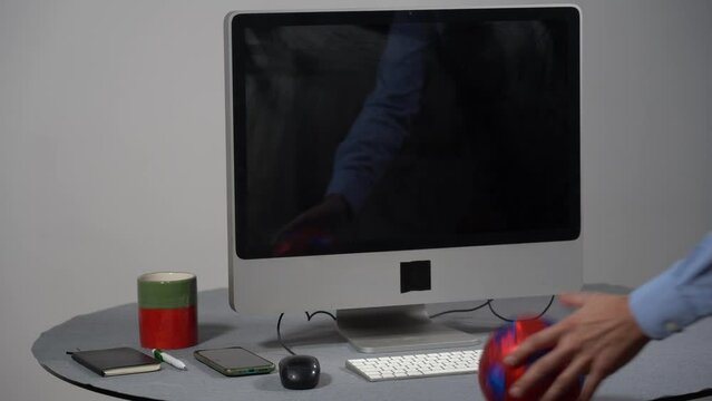 The soccer ball is repeatedly thrown at a workstation's computer monitor - 
children's ball breaks the monitor