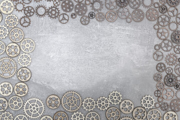 Gray concrete background with gears and copy space.