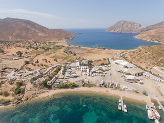Aerial view of harbor full of sailing and fishermen boats at idyllic coast of Greece
