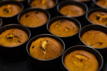 Cupcakes just form oven in cookie cutters. Baking at home. Selective focus.