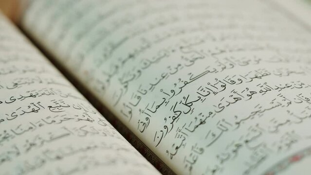 The Holy Quran Book, koran Chapter, flipping pages Close up Macro.