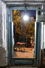 View at the night yard through the door