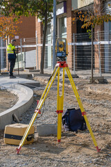 Total station with yellow tachymeter or theodolite with tripod to measure the land surface of the...