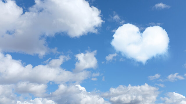 on the blue sky a cloud in the shape of a heart. horizontal frame
