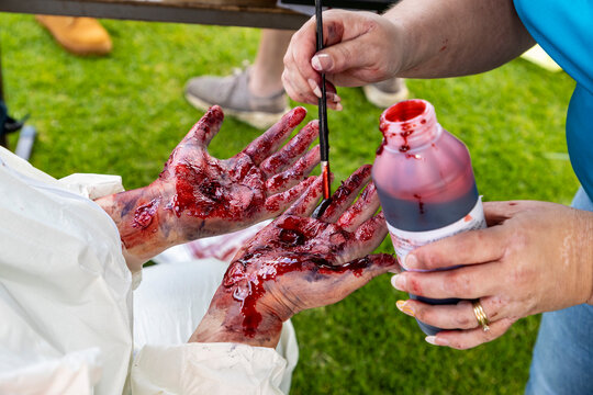 Photograph of artificial blood being put on hands