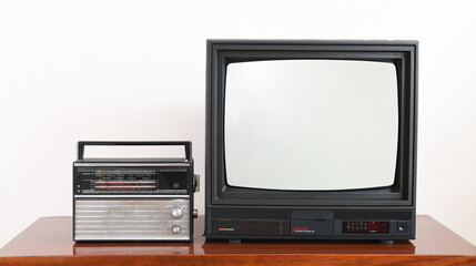 Vintage and tv radio on wooden antique cabinet, old house design. Old black vintage TV. East...
